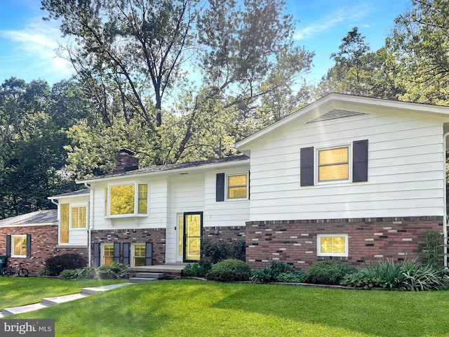 5306 Stone Rd, Frederick, MD 21703 - view of front of house with brick siding, a front yard, and a chimney