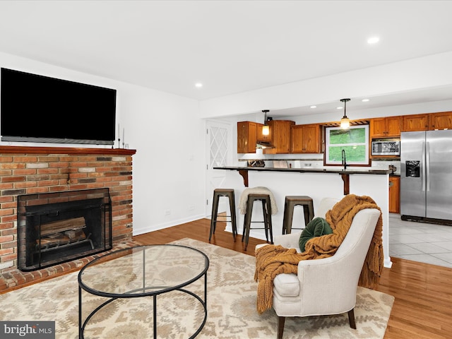 5306 Stone Rd, Frederick, MD 21703 - living area with a fireplace, recessed lighting, and light wood-style floors