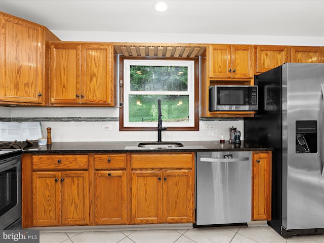 5306 Stone Rd, Frederick, MD 21703 - kitchen with appliances with stainless steel finishes, dark stone counters, decorative backsplash, brown cabinetry, and recessed lighting