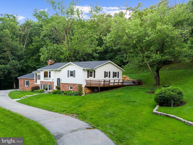 5306 Stone Rd, Frederick, MD 21703 - view of front of home featuring a chimney, a front lawn, a deck, and a forest view