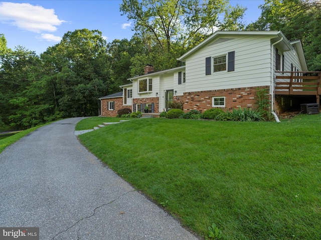 5306 Stone Rd, Frederick, MD 21703 - split foyer home with a front lawn, a chimney, brick siding, and a deck
