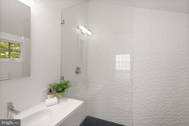 bathroom featuring tile walls and a sink