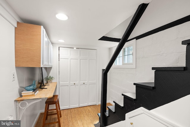 staircase with recessed lighting and wood finished floors