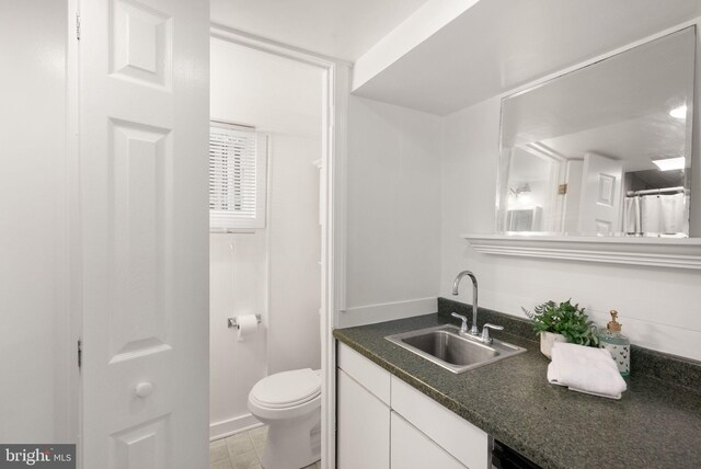 bathroom featuring toilet and vanity