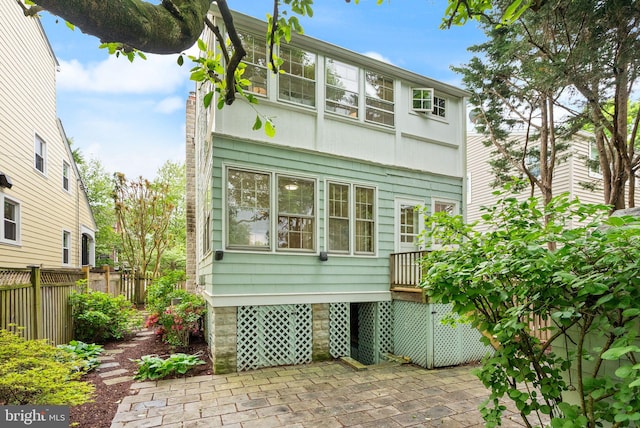 rear view of house with fence