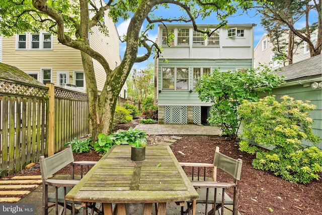 exterior space with a patio area, outdoor dining space, and a fenced backyard