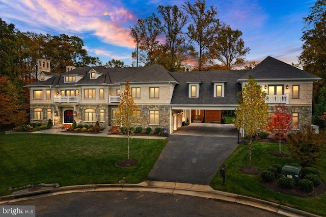1039 Aziza Ct, Great Falls, VA 22066 - view of front of home featuring driveway, a front lawn, stone siding, and a balcony