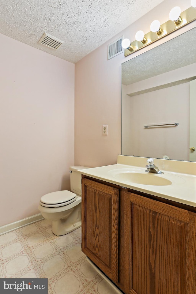 19208 Cross Ridge Dr, Germantown, MD 20874 - half bath with tile patterned floors, toilet, vanity, and a textured ceiling