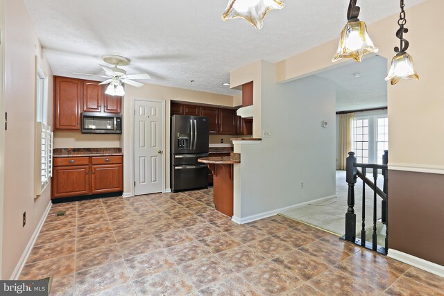 19208 Cross Ridge Dr, Germantown, MD 20874 - kitchen featuring black fridge with ice dispenser, stainless steel microwave, ceiling fan, baseboards, and a textured ceiling