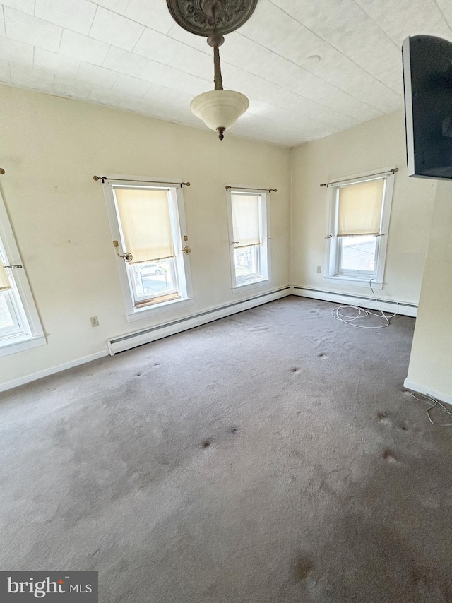 unfurnished room with baseboards and carpet floors