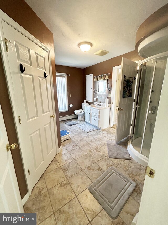 full bath with toilet, vanity, a baseboard heating unit, and a stall shower
