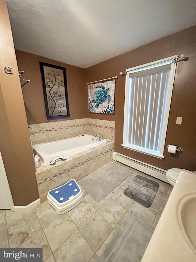 full bathroom with a baseboard radiator, toilet, baseboards, tile patterned flooring, and a garden tub