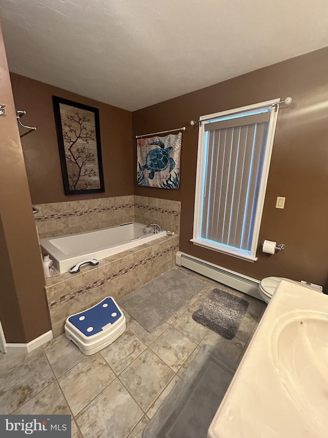 bathroom featuring a baseboard radiator, a garden tub, baseboards, and tile patterned floors