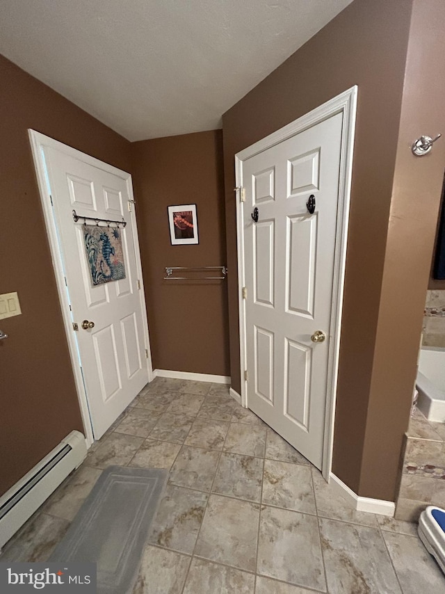foyer with baseboards and baseboard heating