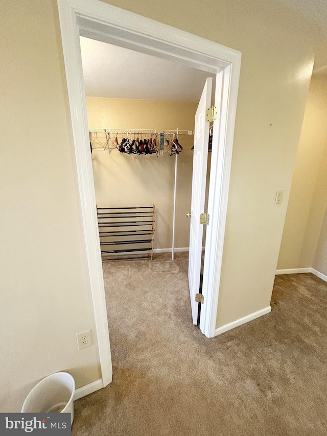 corridor featuring carpet and baseboards