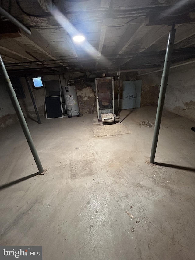 unfinished basement featuring water heater