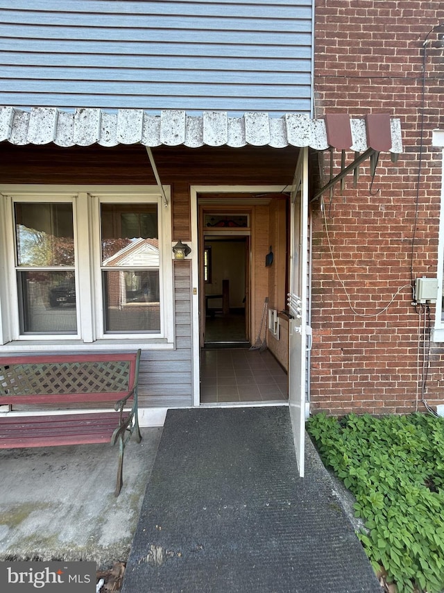 property entrance featuring brick siding