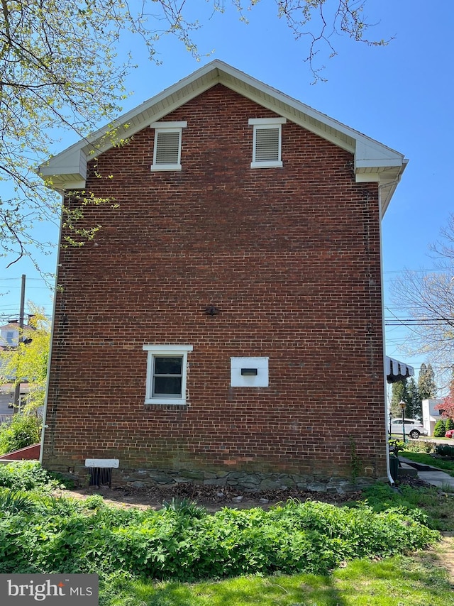 view of side of property with brick siding