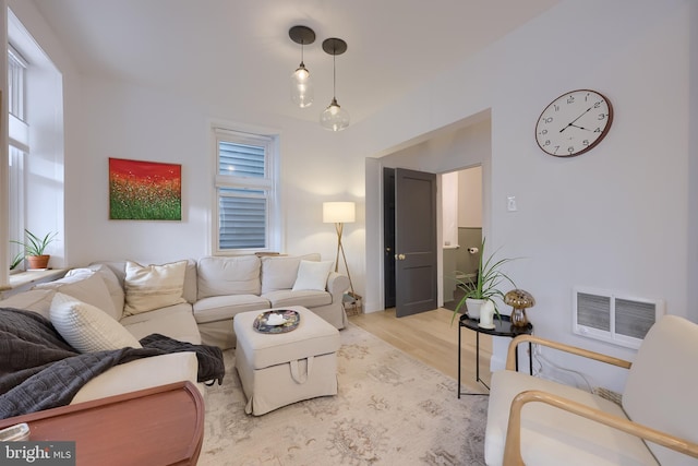 living area with light wood-style flooring and visible vents