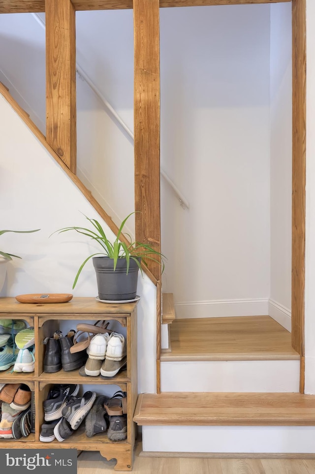 stairway featuring wood finished floors and baseboards