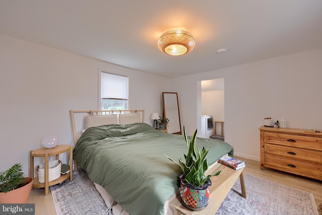 bedroom with baseboards and light wood-style floors