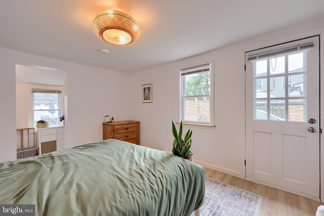 bedroom featuring light wood-type flooring and baseboards