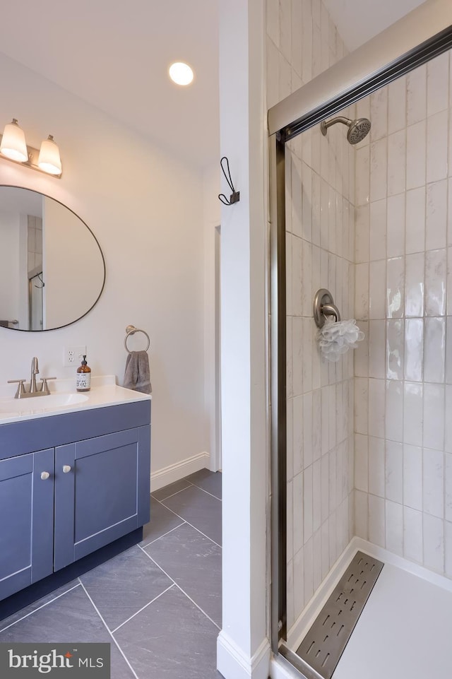 full bath with vanity, a tile shower, and recessed lighting