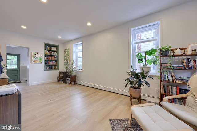sitting room featuring light wood finished floors, recessed lighting, and plenty of natural light