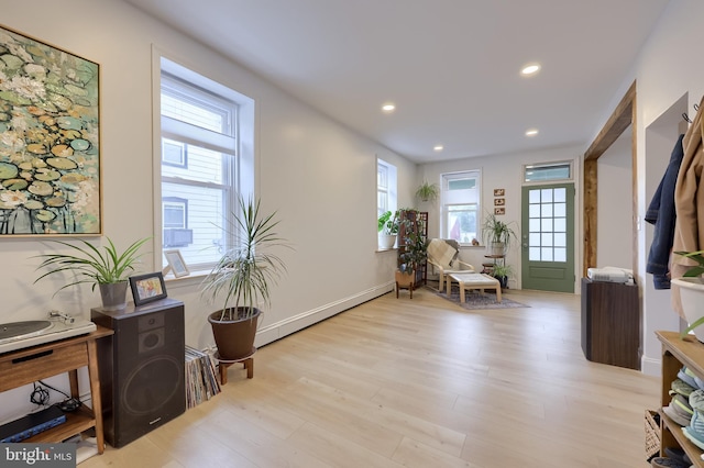 sitting room with light wood finished floors and recessed lighting
