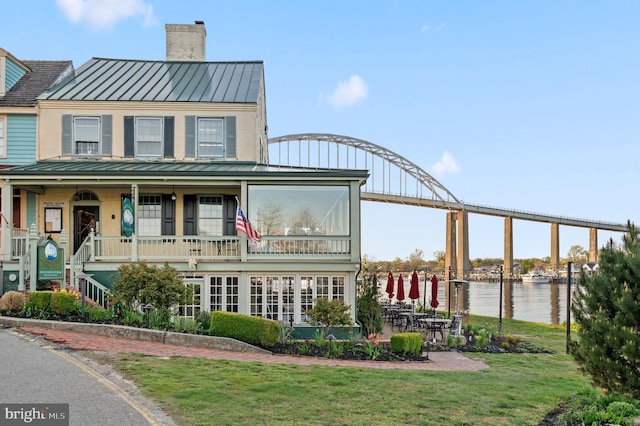409 Crownleaf Dr, Middletown, DE 19709 - exterior space with a yard, a chimney, metal roof, and a standing seam roof