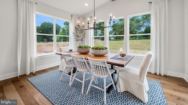 409 Crownleaf Dr, Middletown, DE 19709 - dining space with baseboards, an inviting chandelier, wood-type flooring, and vaulted ceiling