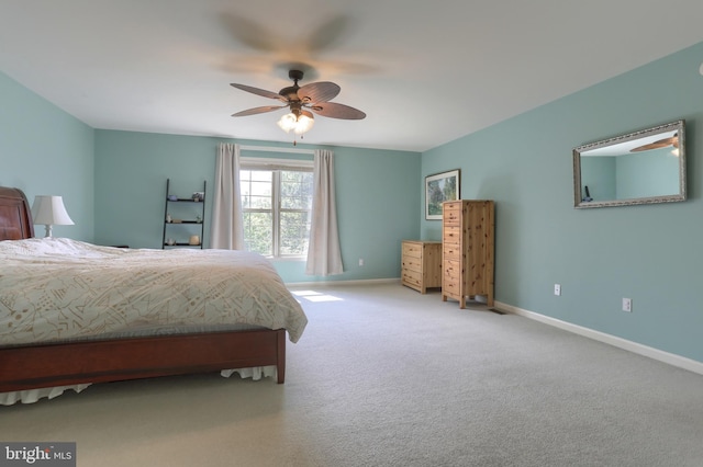 carpeted bedroom with baseboards and ceiling fan