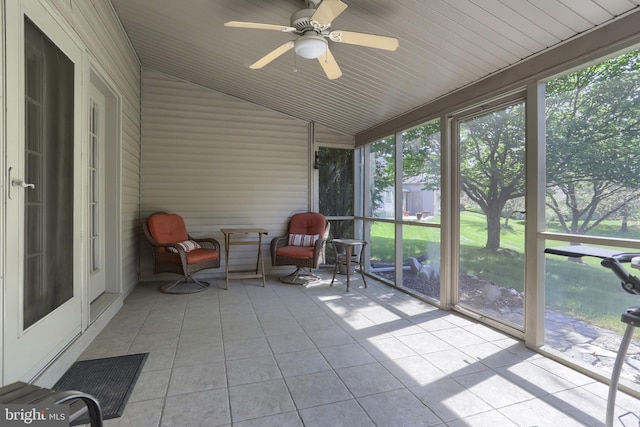 sunroom / solarium featuring a ceiling fan and lofted ceiling