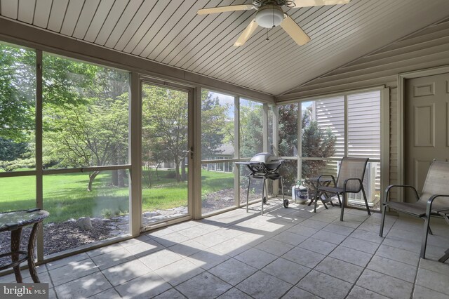 sunroom / solarium with ceiling fan, lofted ceiling, and healthy amount of natural light