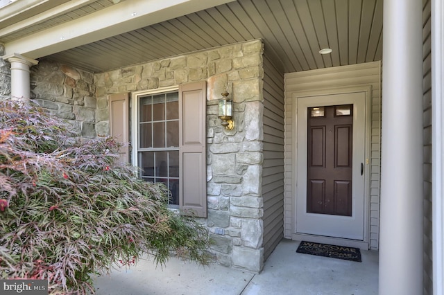 entrance to property with stone siding