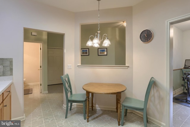 dining room with a chandelier, baseboards, and light tile patterned floors