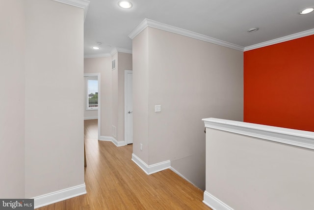 corridor with recessed lighting, an upstairs landing, crown molding, light wood-style floors, and baseboards