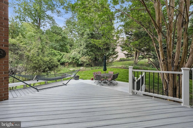 wooden deck featuring outdoor dining area