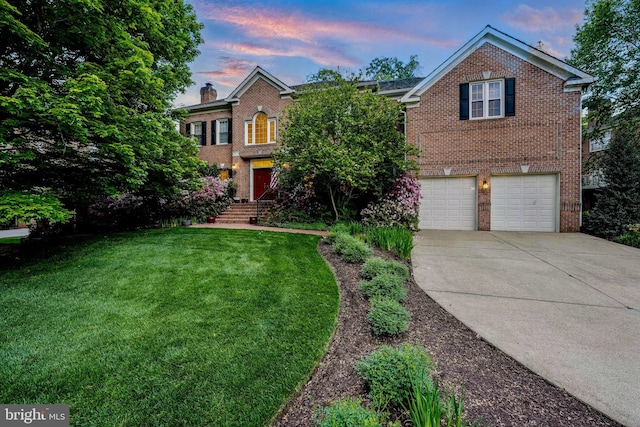 view of front of property featuring brick siding, driveway, a garage, and a front yard