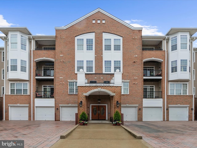 view of building exterior with a garage and driveway