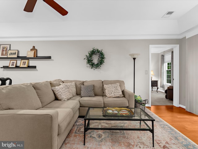 living area featuring ceiling fan, wood finished floors, and baseboards