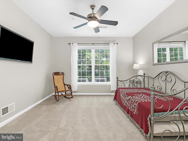 bedroom featuring multiple windows, carpet, baseboards, and a ceiling fan