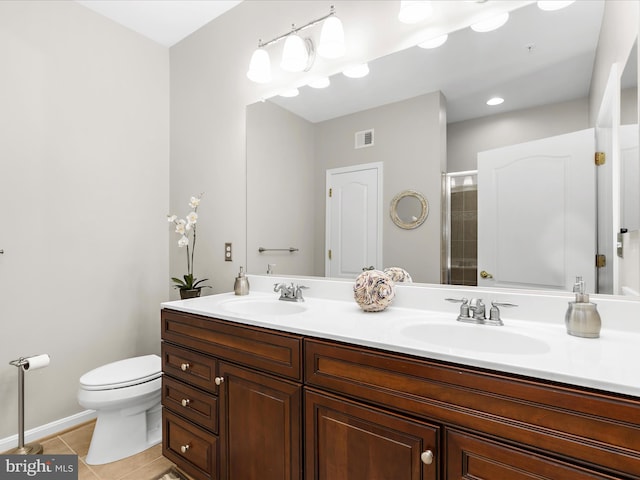 full bath featuring tile patterned flooring, a shower stall, toilet, double vanity, and baseboards
