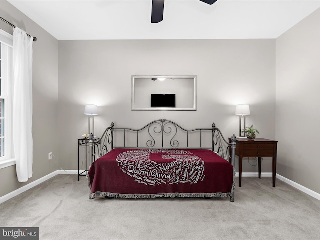 carpeted bedroom with baseboards and ceiling fan