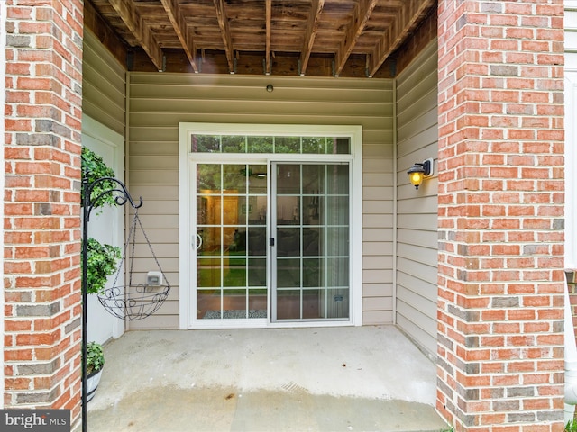 property entrance featuring brick siding