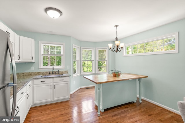 11080 Burwell Rd, Nokesville, VA 20181 - kitchen featuring a sink, wood counters, a chandelier, and healthy amount of natural light