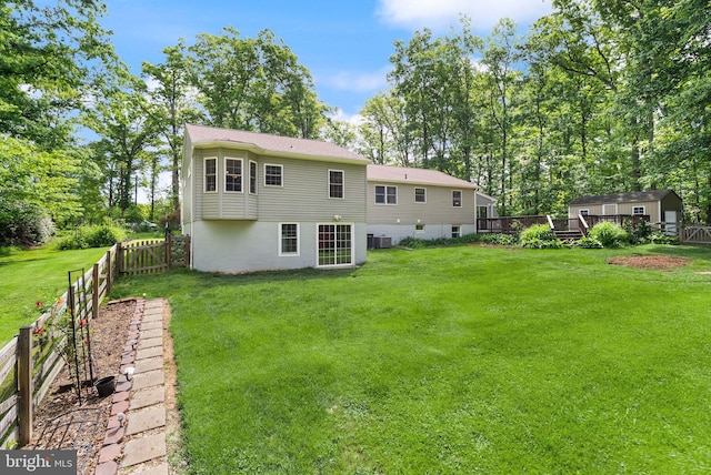 11080 Burwell Rd, Nokesville, VA 20181 - back of property featuring an outbuilding, a storage shed, a deck, central air condition unit, and view of scattered trees