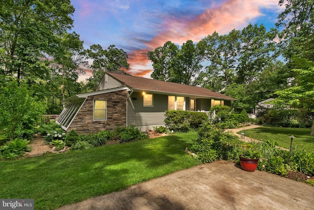 11080 Burwell Rd, Nokesville, VA 20181 - property exterior at dusk featuring stone siding and a lawn