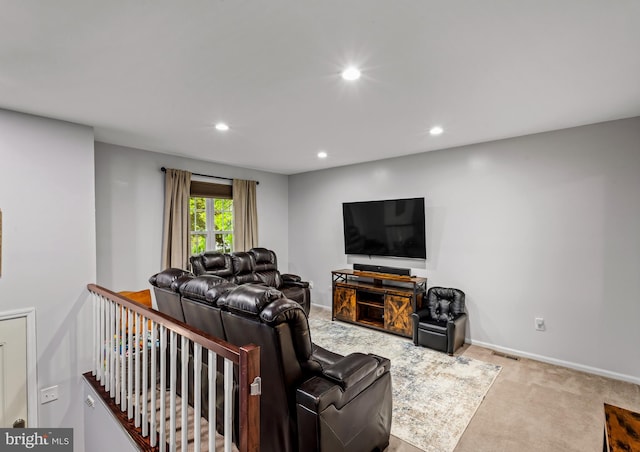 carpeted living area featuring recessed lighting and baseboards