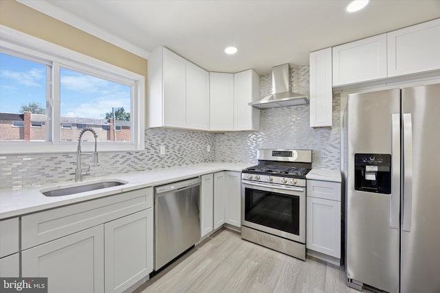 3605 Essex Ln, Philadelphia, PA 19114 - kitchen with stainless steel appliances, a sink, wall chimney exhaust hood, light wood-type flooring, and light countertops